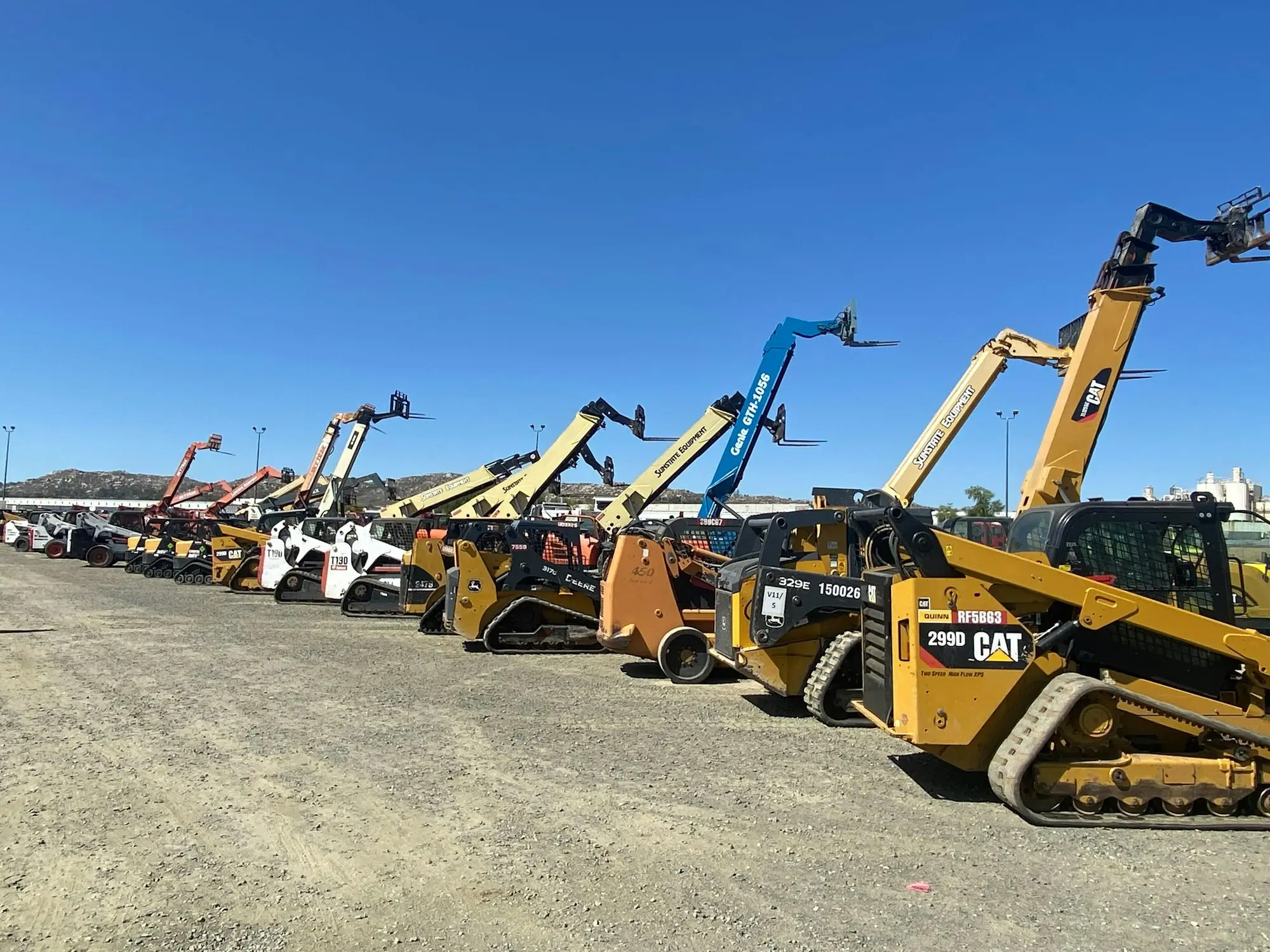 A group of yellow construction vehicles, the scale of equipment a larger loan can cover