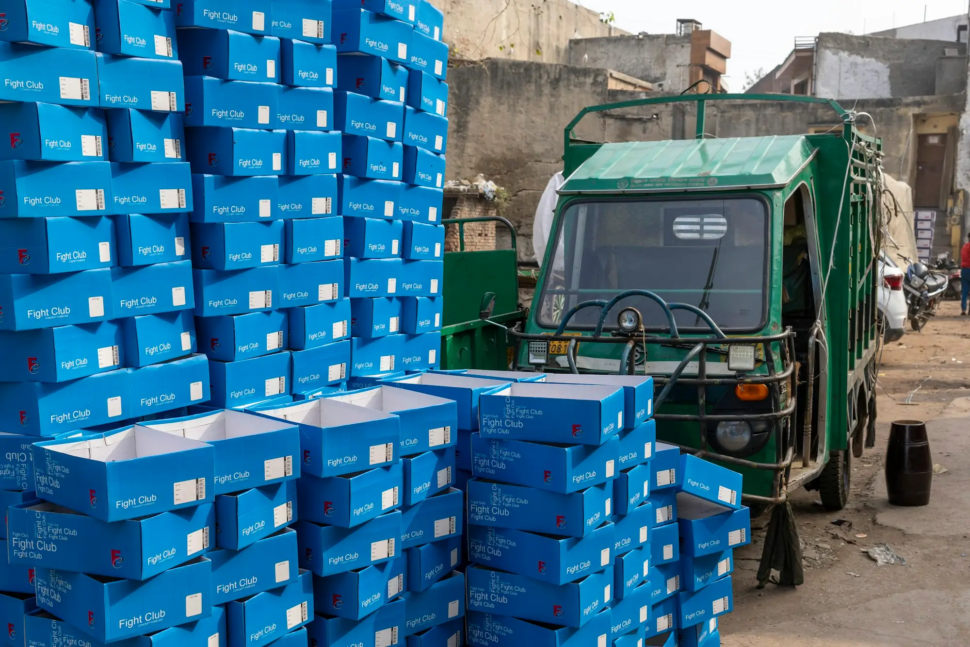A green truck beside stacked boxes, a delivery business smoothing cash flow