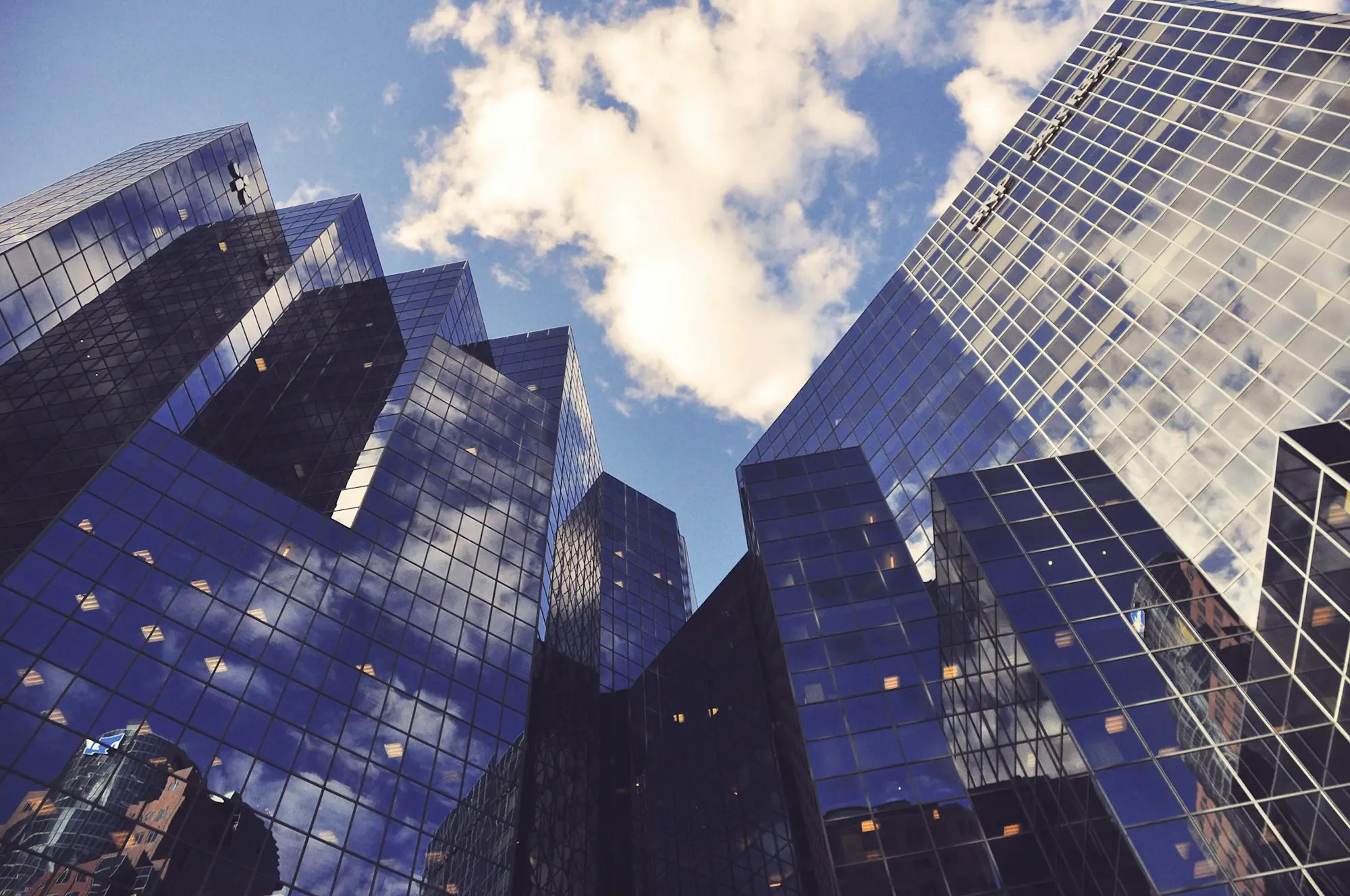 A glass office tower viewed from below, the commercial property behind multi-million dollar funding