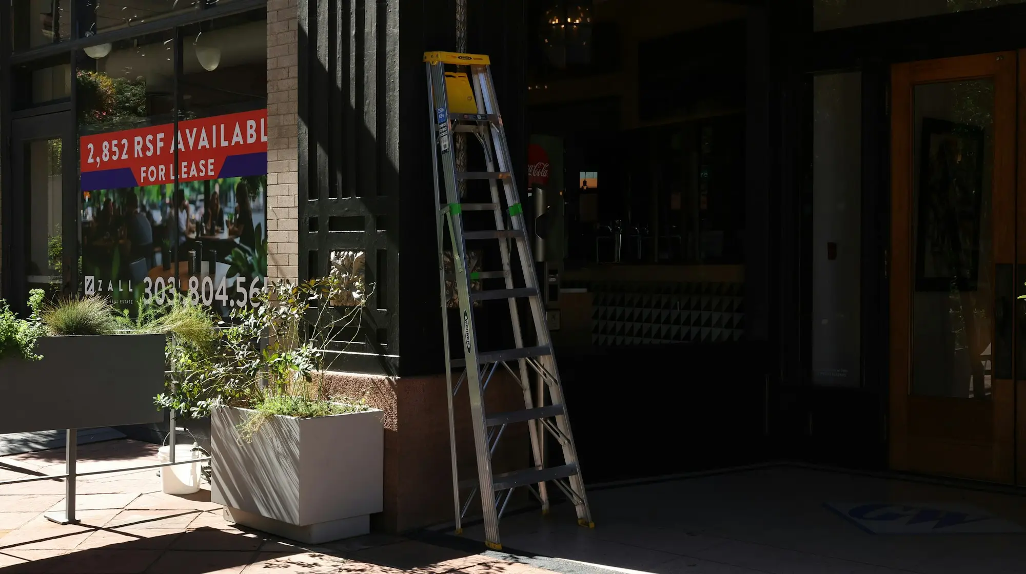 A building entrance with a for lease sign, premises changing hands while a bridging loan covers the gap
