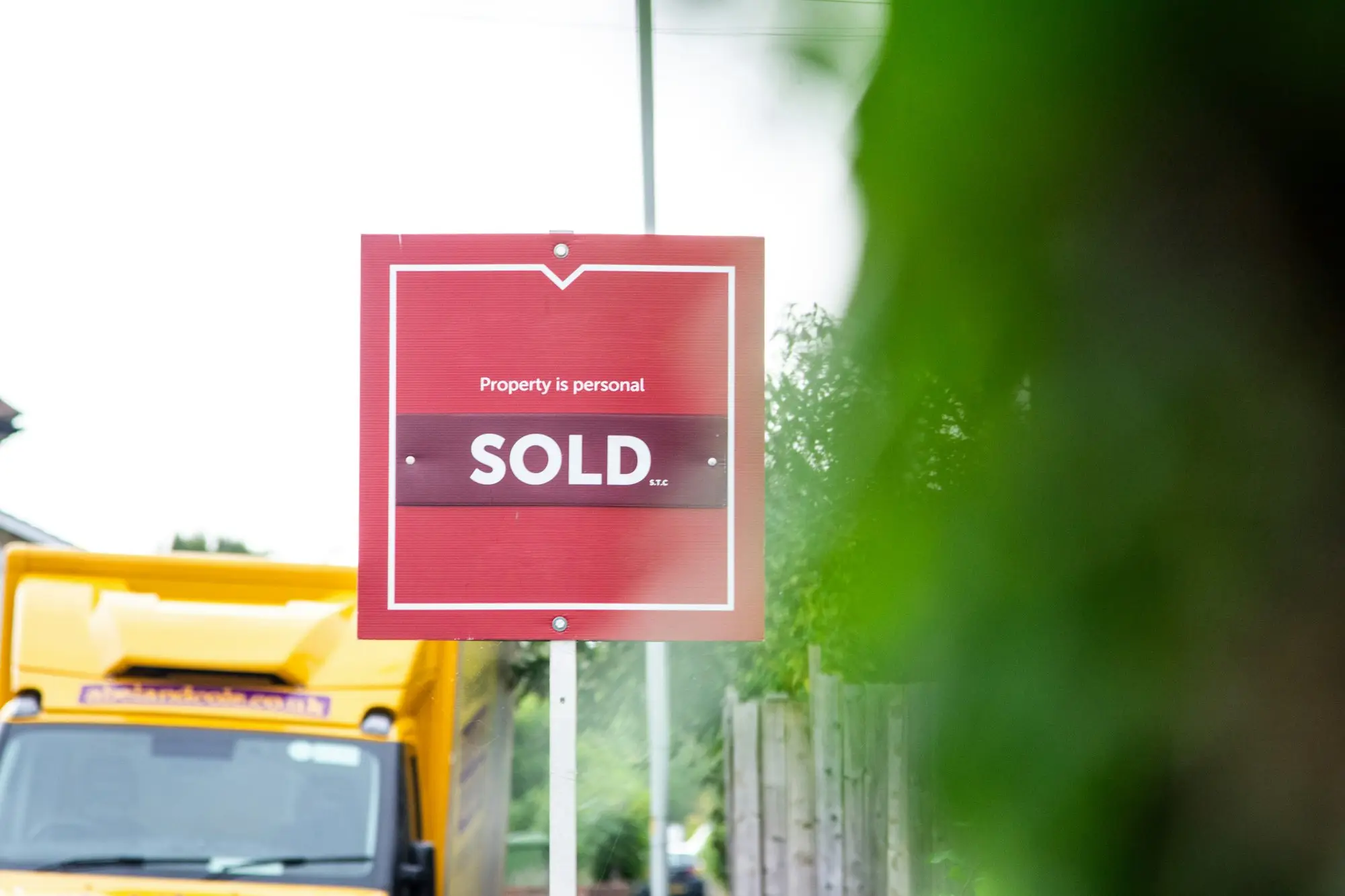A red sold sign beside a road, the property sale that repays a caveat loan