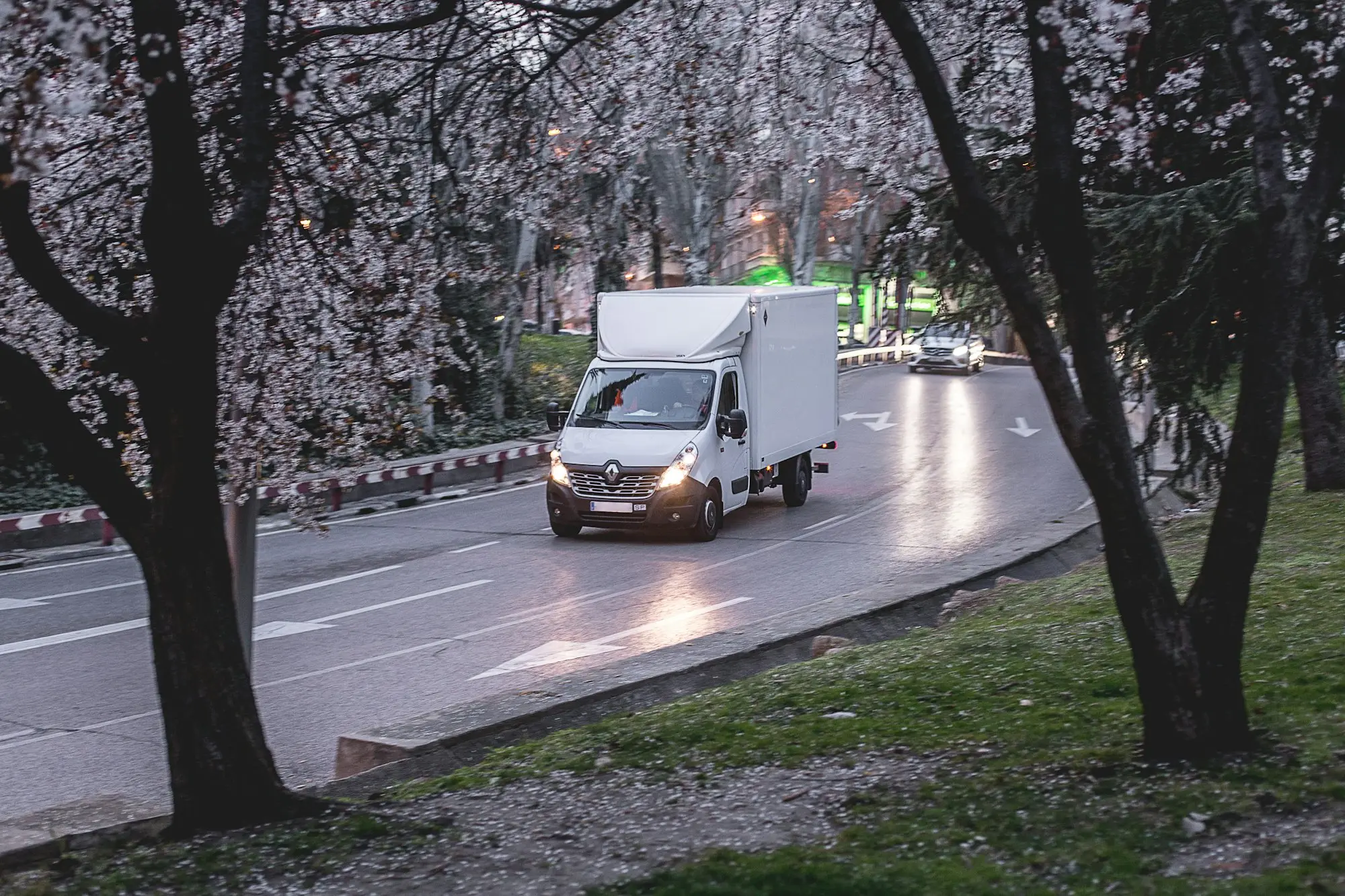 A white work van on a tree-lined road, a trading business that can borrow without property